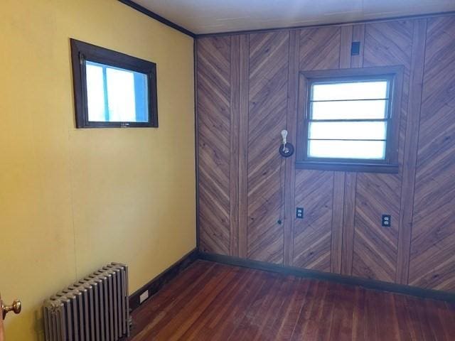 doorway featuring dark hardwood / wood-style flooring, radiator heating unit, and plenty of natural light