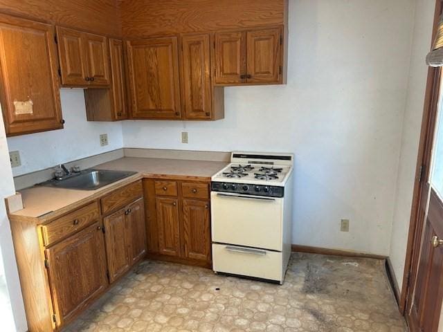 kitchen featuring white range and sink