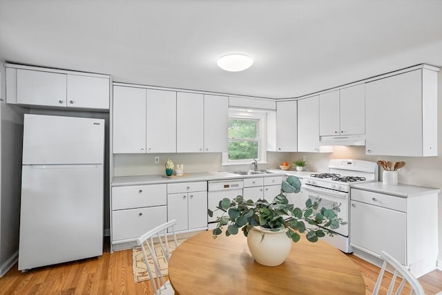 11 Anniversary Way, Billerica, MA 01821 - kitchen with white appliances, under cabinet range hood, light countertops, white cabinetry, and light wood-style floors