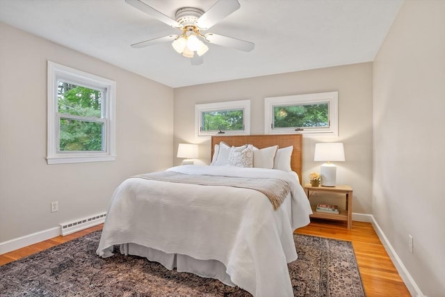 11 Anniversary Way, Billerica, MA 01821 - bedroom featuring a baseboard heating unit, multiple windows, and light wood-style flooring