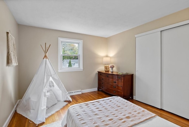 11 Anniversary Way, Billerica, MA 01821 - bedroom with wood finished floors, a closet, and a baseboard heating unit