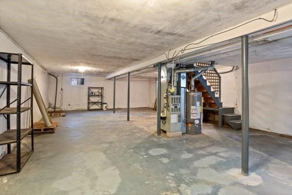 11 Anniversary Way, Billerica, MA 01821 - unfinished below grade area featuring gas water heater, stairway, and heating unit