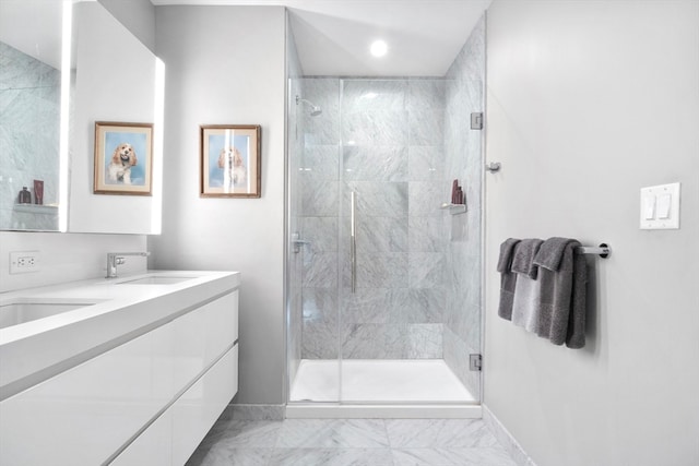 bathroom with vanity and a shower with shower door