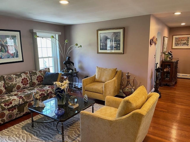 living room featuring a baseboard radiator, wood finished floors, and recessed lighting