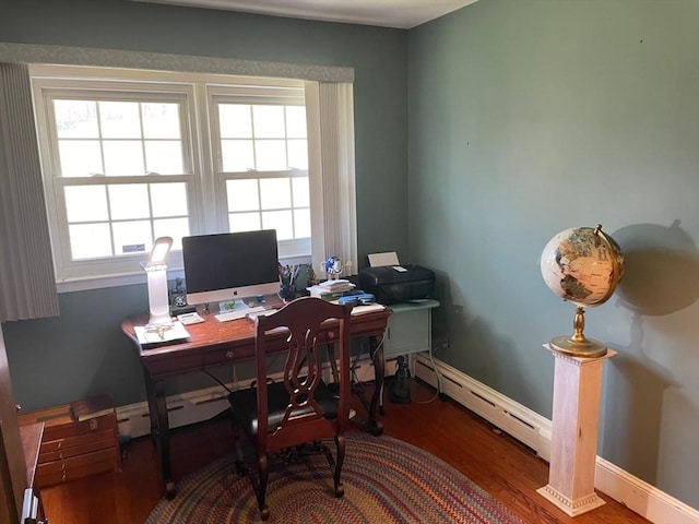 home office with a baseboard heating unit, baseboards, and wood finished floors