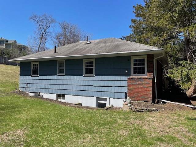 view of side of home featuring a yard