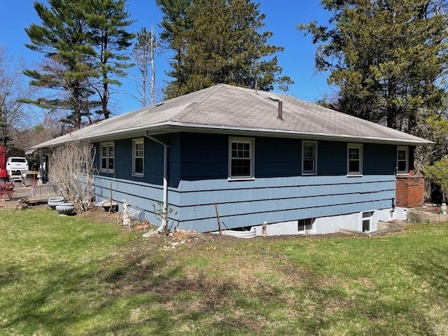 view of side of home with a lawn