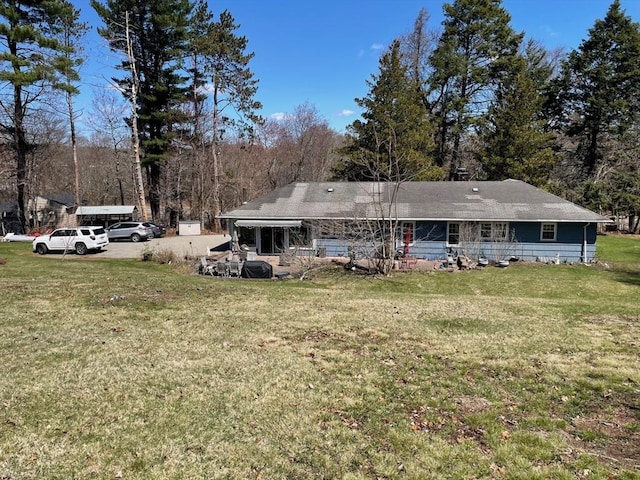 rear view of house featuring a yard