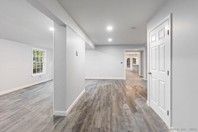 corridor with dark hardwood / wood-style flooring