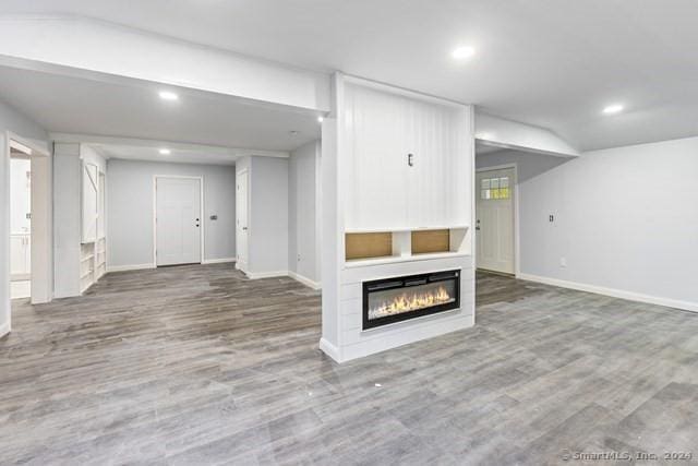 unfurnished living room with wood-type flooring