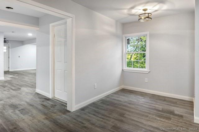 spare room with dark wood-type flooring