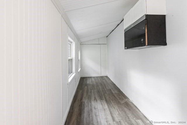 hall with hardwood / wood-style flooring and lofted ceiling