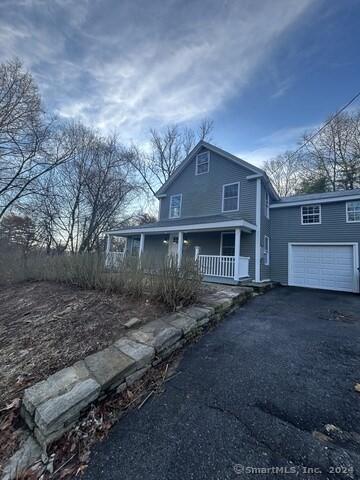 view of front of house with a porch and a garage