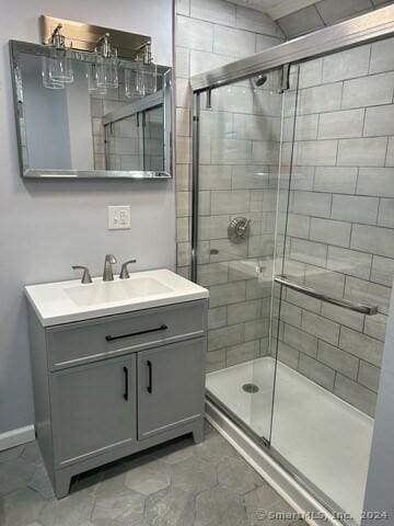 bathroom with walk in shower and vanity