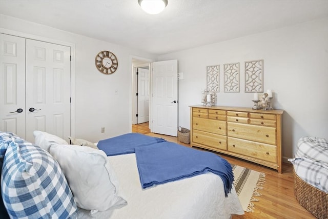 bedroom with a closet and hardwood / wood-style floors