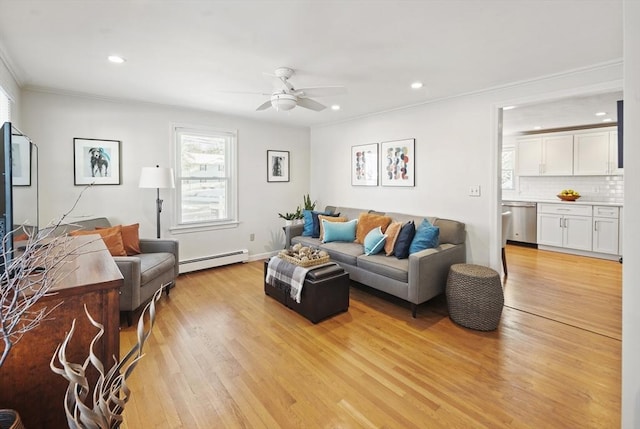 living room with light wood-type flooring, ceiling fan, crown molding, and a baseboard radiator