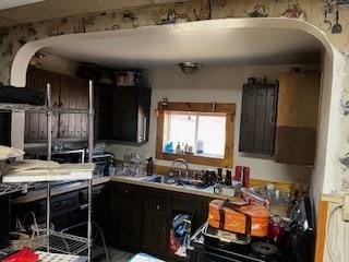 kitchen featuring dark brown cabinets and sink