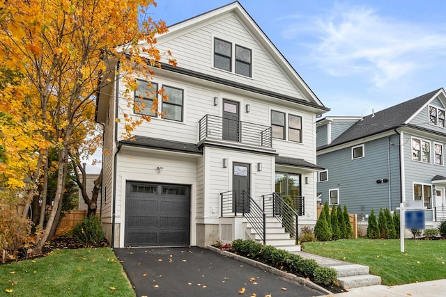 view of front of house featuring a garage and a front lawn