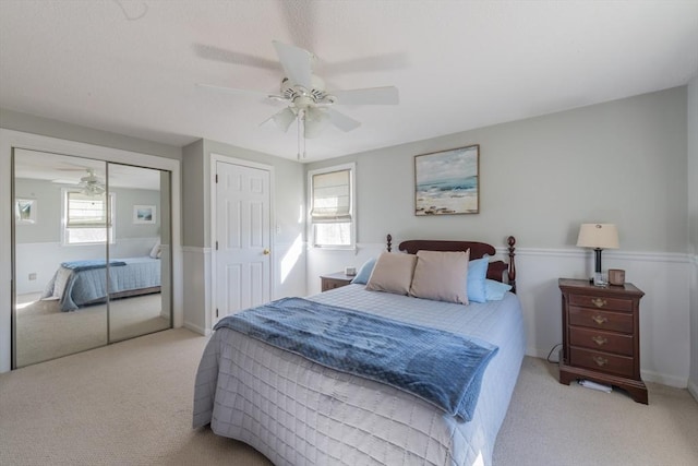 carpeted bedroom with a closet and a ceiling fan