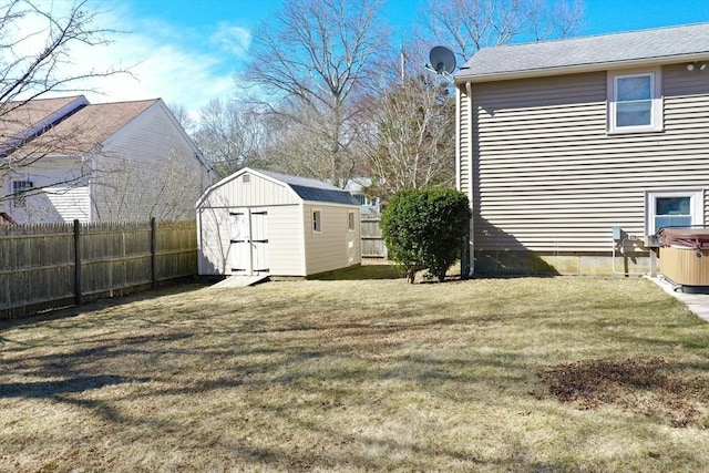 view of yard with an outbuilding, a storage unit, and a fenced backyard