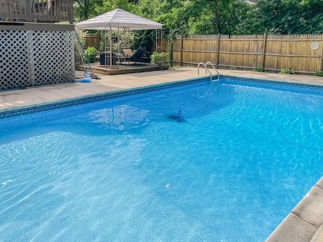 view of swimming pool with a fenced in pool, a deck, and fence