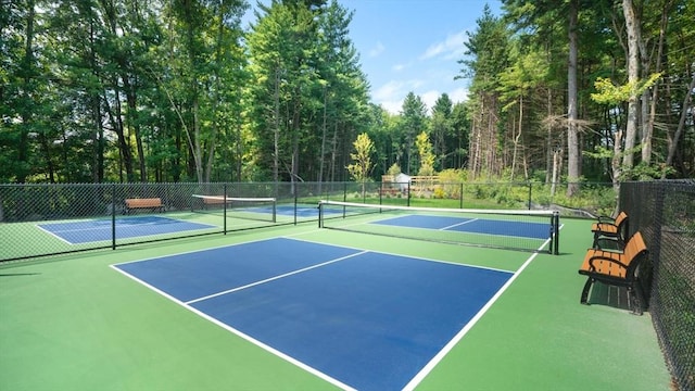 view of tennis court with basketball hoop