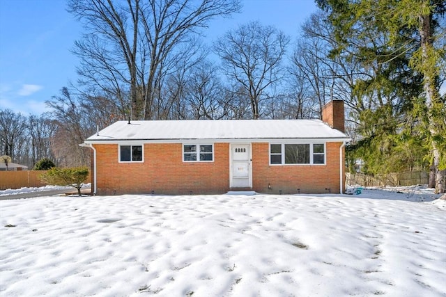 ranch-style house featuring crawl space, brick siding, and a chimney