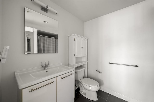 full bathroom with toilet, vanity, and tile patterned floors