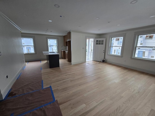 9 Swan St, Beverly, MA 01915 - unfurnished living room featuring light wood-type flooring and ornamental molding