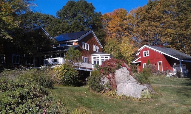 view of side of property with a yard