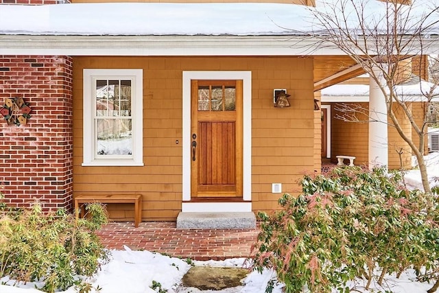 entrance to property featuring brick siding