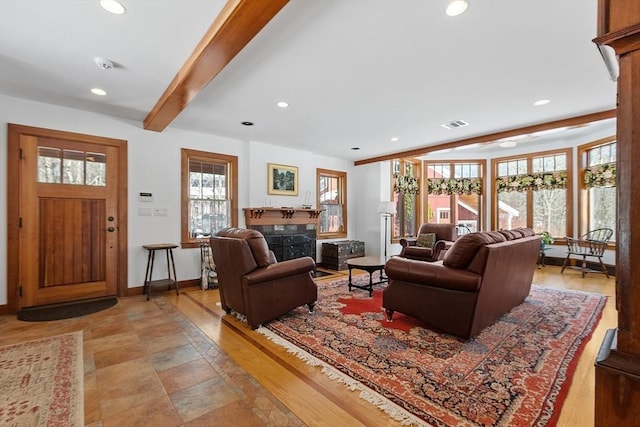 living room with baseboards, a high end fireplace, beam ceiling, and recessed lighting