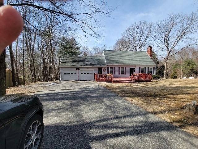 82 Prince Rd, Southbridge, MA 01550 - view of front of home with asphalt driveway, an attached garage, a chimney, and a wooden deck