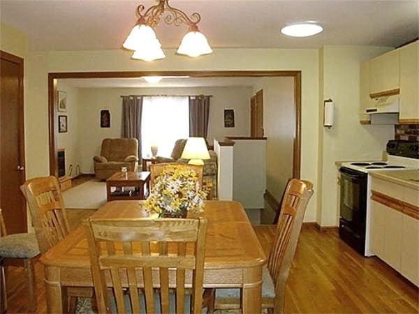 32 Hilltop Ln Unit 2, Easton, MA 02375 - dining area with a chandelier and wood finished floors