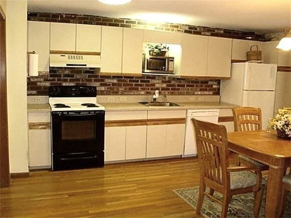 32 Hilltop Ln Unit 2, Easton, MA 02375 - kitchen with white appliances, under cabinet range hood, light countertops, and wood finished floors