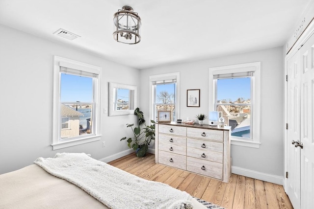 bedroom with light hardwood / wood-style flooring and a closet