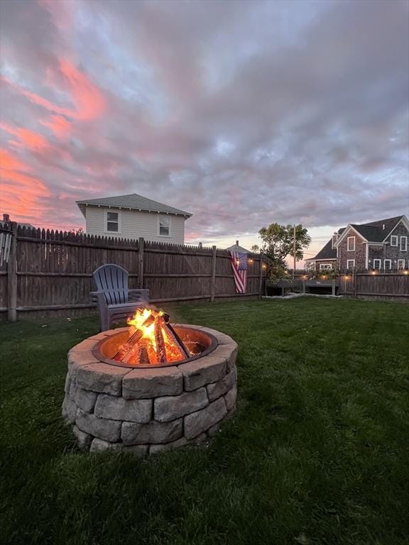 yard at dusk with an outdoor fire pit