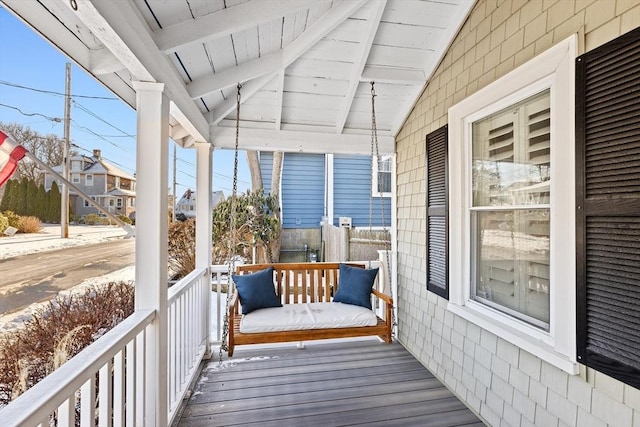 wooden terrace featuring covered porch