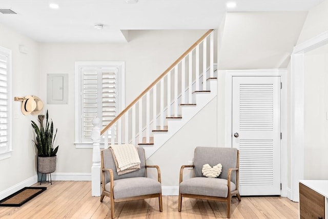 interior space featuring electric panel and light wood-type flooring