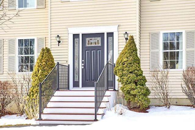 view of snow covered property entrance