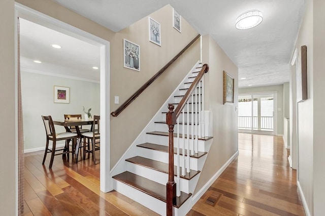 staircase with hardwood / wood-style flooring