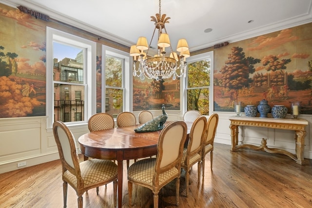 dining room with a chandelier, light hardwood / wood-style flooring, crown molding, and a healthy amount of sunlight