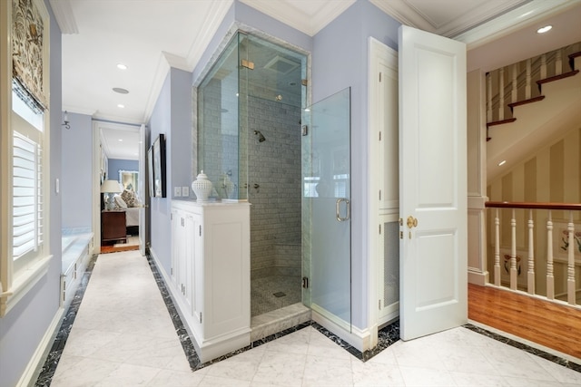 bathroom featuring ornamental molding, a shower with shower door, and hardwood / wood-style flooring