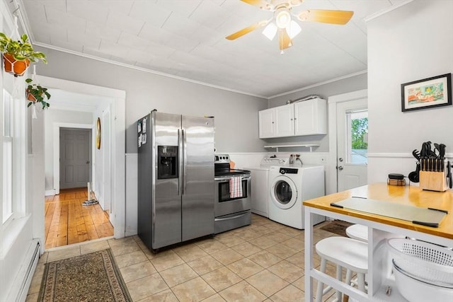 kitchen with stainless steel appliances, a ceiling fan, ornamental molding, a baseboard heating unit, and white cabinets