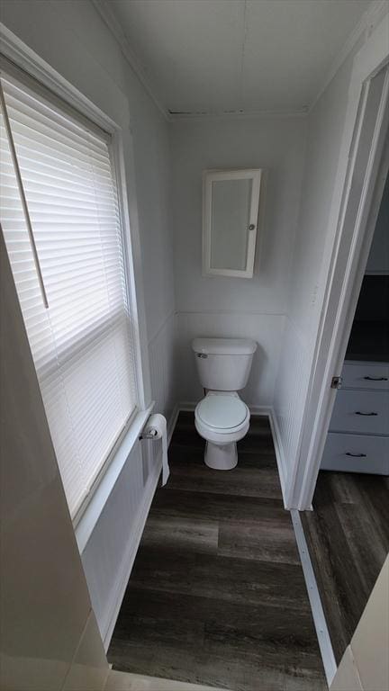 bathroom with toilet, wood finished floors, and ornamental molding