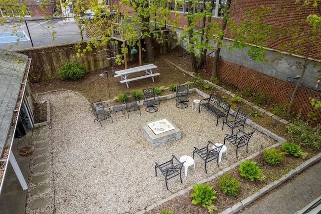 view of yard featuring a fire pit, fence, and a patio