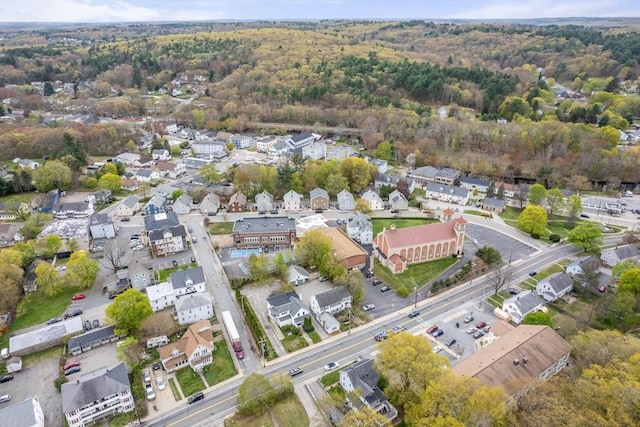 aerial view of property's location with nearby suburban area and a forest