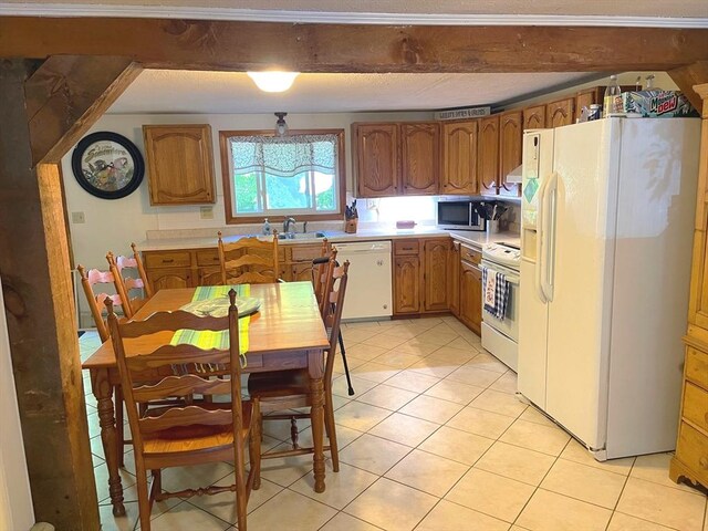 8 Sandy Ln, Pembroke, MA 02359 - kitchen with white appliances, light countertops, light tile patterned floors, and brown cabinetry
