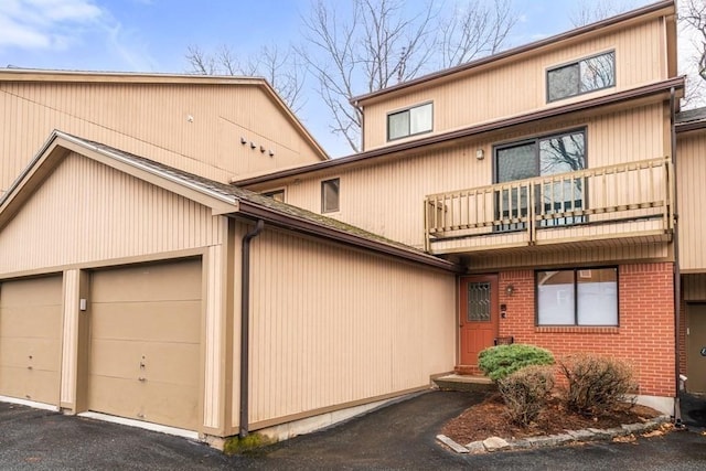 19 Burnham St Unit C2, Belmont, MA 02478 - view of front of property featuring a balcony, a garage, and brick siding