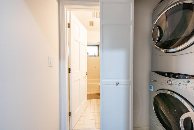 19 Burnham St Unit C2, Belmont, MA 02478 - laundry room featuring stacked washer and clothes dryer and light tile patterned floors